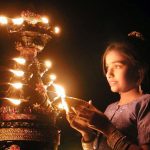 INDIAN GIRL LIGHTS A DEEPAWALI LAMP IN AHMEDABAD